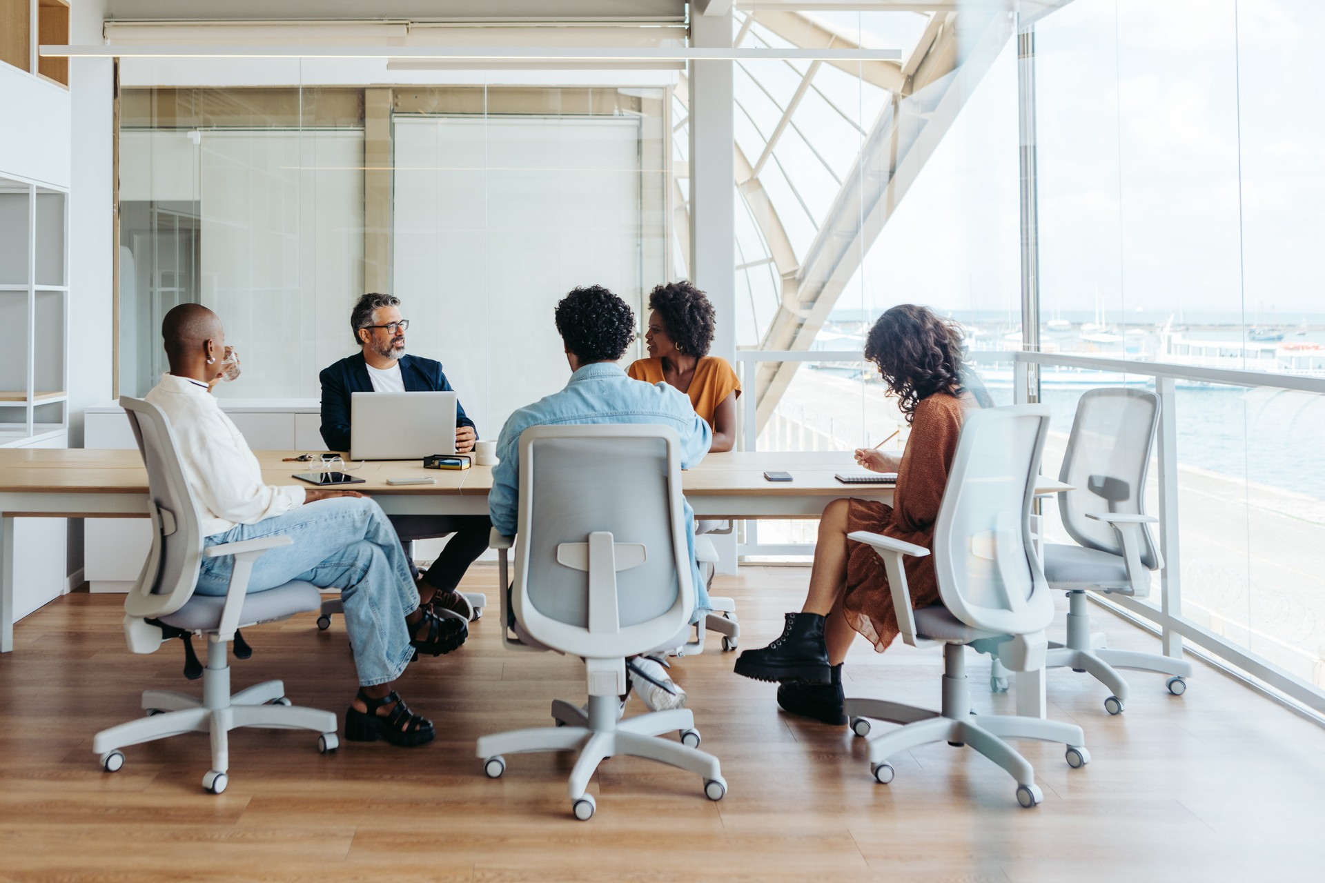 Diverse group of professionals collaborating and discussing ideas in a business meeting